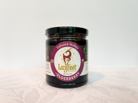 A 12oz jar of Elderberry Infused raw honey.
