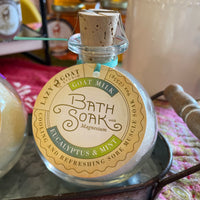 A 9oz glass jar of Eucalyptus & Mint Bath Soak with magnesium.