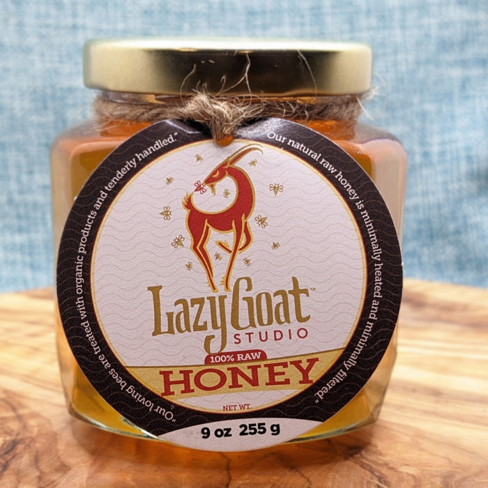 9oz of Raw Honey in a decorative glass jar.
