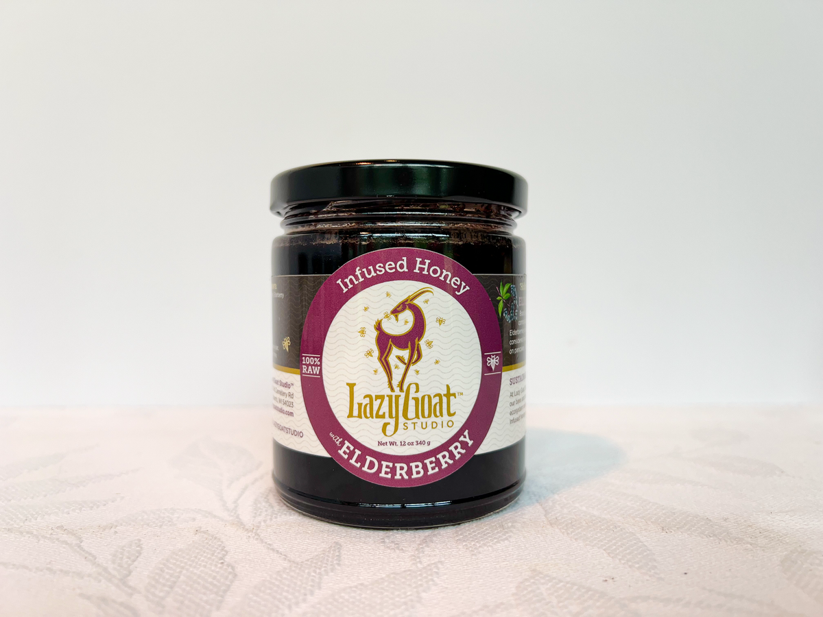 A 12oz jar of Elderberry Infused raw honey.