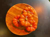 Beeswax orange Pumpkin candles with green stems.