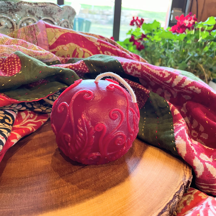 A 3" red sphere Beeswax Candle.