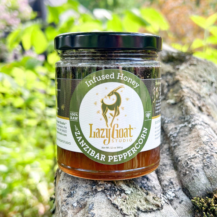 Zanzibar Peppercorn infused raw honey in a 12oz glass jar.