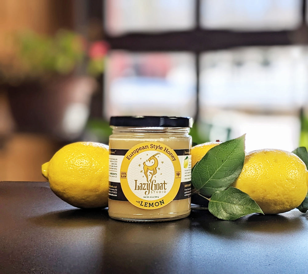 A 12oz glass jar of Lazy Goat Studio Lemon Creamed Honey. All raw honey.